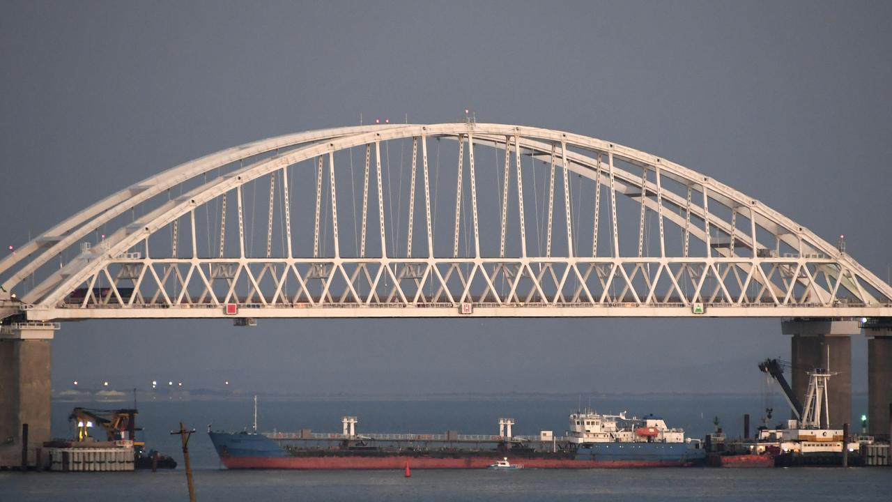 A ship under the Kerch bridge blocks the passage to the Kerch Strait near Kerch, Crimea, on Sunday, November 25. Russia and Ukraine traded accusations over an incident at sea increasing tensions between both countries. Picture: AP