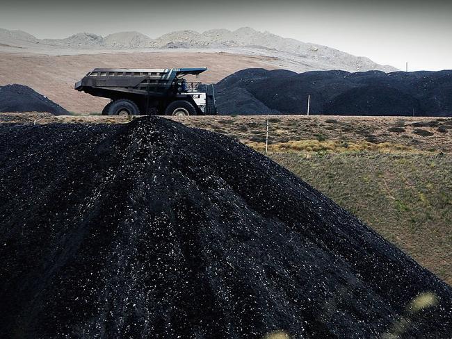 MUSWELLBROOK, AUSTRALIA - FEBRUARY 15:  A coal truck passes a huge pile of coal at BHP Billiton's Mt Arthur coal mine February 15, 2006 in Muswellbrook, Australia. BHP today posted the biggest interim profit in Australian corporate history. The world's biggest mining company announced a half-year after tax profit of $5.9 billion AUD ($4.37 billion USD) a rise of almost 48 per cent from last year.  (Photo by Ian Waldie/Getty Images)