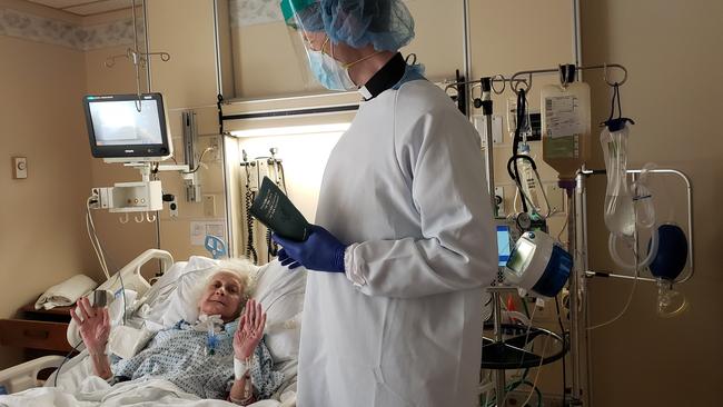 Adelaide-born priest Stephen Howe anoints an elderly woman in intensive care at St John’s Riverside Hospital in Yonkers, New York; she has since recovered sufficiently to leave the ICU.