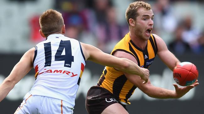 Tom Mitchell fires off a handball for the Hawks. Picture: Getty Images