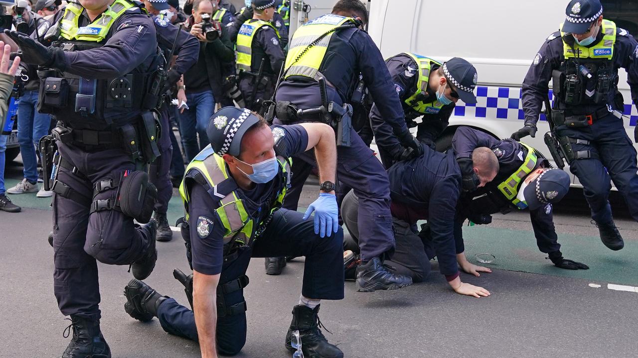 Police officers detain a man. Picture: Scott Barbour/AAP