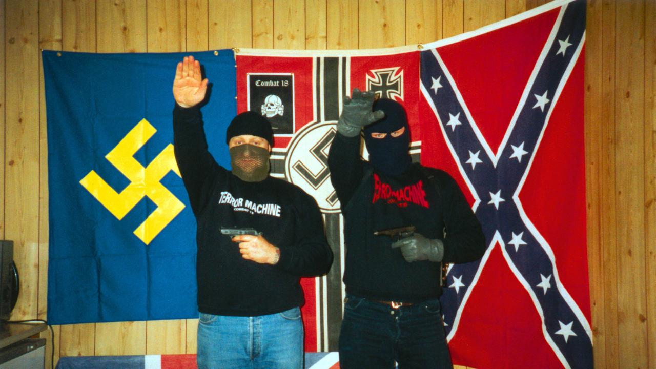 Combat 18 members 'sieg heil' while posing with handguns. Del Connor (L), one time C18 member suspected of being the leader of White Wolves - neo-nazi racism balaclava disguises