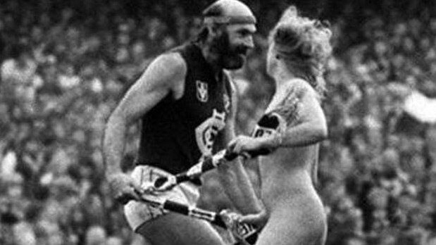 The streaker goes toe to toe with Carlton legend Bruce Doull during the VFL Grand Final in 1982.