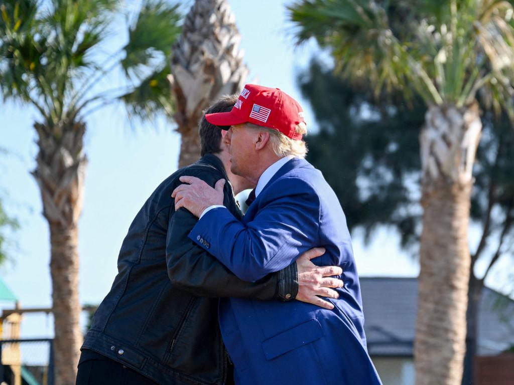 The billionaire and President-elect hugged. Picture: Getty Images via AFP)