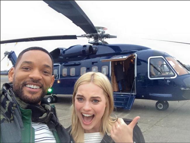 Margot Robbie is excited as she prepares to boars a chopper with Will Smith following the London premiere of their film Focus. Picture: Facebook / Will Smith