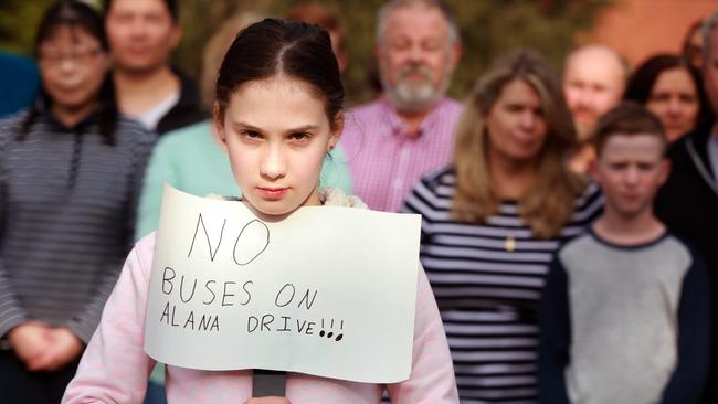 Sophie Hopwood, 10, poses for photographs holding a sign protesting the proposed bus stops for Alana Dr, West Pennnant. West Pennant Hills. Picture: AAP Image / Angelo Velardo