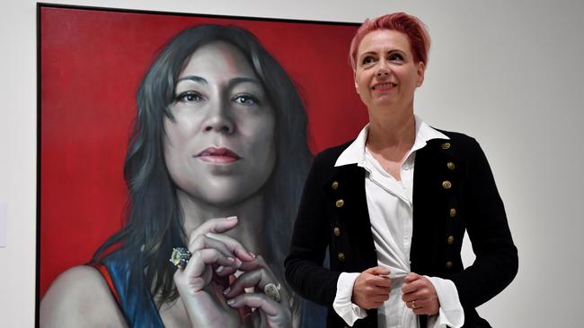 Artist Kathrin Longhurst poses for a photo with her Packing Room prize winning portrait of singer Kate Ceberano at the Gallery of NSW in Sydney. Picture: Joel Carrett/NCA NewsWire