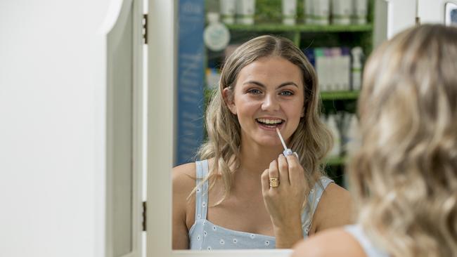 Burleigh business MooGoo's vegan makeup brand Dusty Girl has been growing in popularity. Jade Ricourt is pictured using the company’s lip gloss. Picture: Jerad Williams