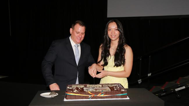 Ms Lov with her principal, Mr Lucas Hurley, cutting the cake as the 2024 Graduate of the Year. Picture: Supplied