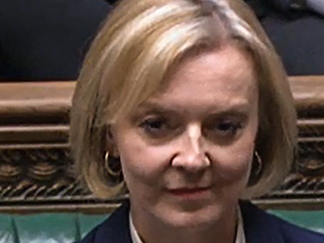 A video grab from footage broadcast by the UK Parliament's Parliamentary Recording Unit (PRU) shows Britain's Prime Minister Liz Truss reacting following Britain's Chancellor of the Exchequer Jeremy Hunt presentation of tax and spending measures, part of medium-term fiscal plan at the House of Commons, in London, on October 17, 2022. - The British government on October 17, 2022 axed almost all of its debt-fuelled tax cuts unveiled last month to avert fresh markets chaos, in a humiliating climbdown for embattled Prime Minister Liz Truss. The shock move by new finance chief Jeremy Hunt, parachuted into the job on Friday to replace sacked Kwasi Kwarteng, leaves Truss' position in a precarious state after a series of embarrassing U-turns. (Photo by PRU / AFP) / RESTRICTED TO EDITORIAL USE - MANDATORY CREDIT 