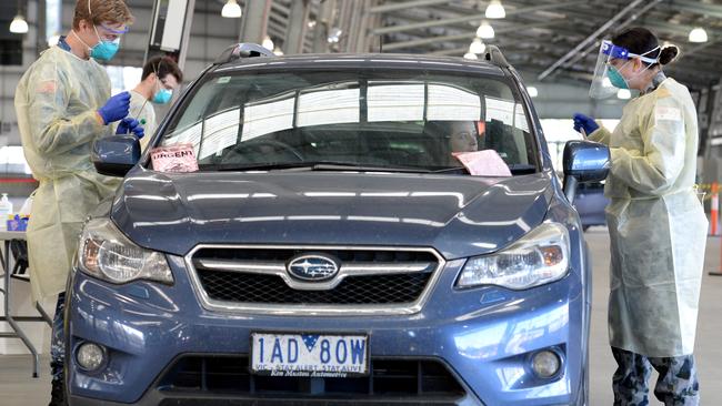 Members of the defence force at the Melbourne Showgrounds testing centre. Picture: Andrew Henshaw