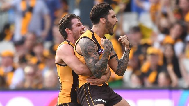 Chad Wingard gets a hug from Isaac Smith after kicking a goal against the Kangaroos. Picture: AAP