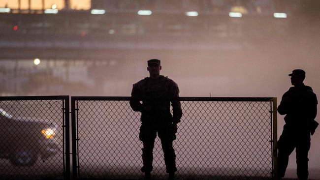 National Guard soldiers stand guard on the banks of the Rio Grande river at Shelby Park on January 12, 2024 in Eagle Pass, Texas. The Texas National Guard continues its blockade and surveillance of Shelby Park in an effort to deter illegal immigration. The Department of Justice has accused the Texas National Guard of blocking Border Patrol agents from carrying out their duties along the river. Brandon Bell/Getty Images/AFP (Photo by Brandon Bell / GETTY IMAGES NORTH AMERICA / Getty Images via AFP)