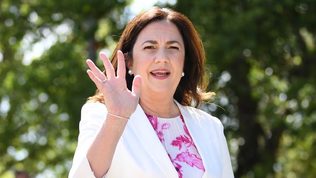 Queensland Premier Annastacia Palaszczuk waves to voters outside at a polling booth at Aspley State School on state Election Day. Picture: NCA NewsWire / Dan Peled