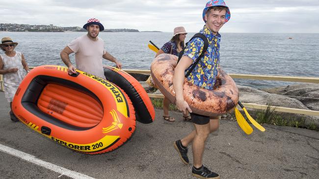 Participants walk from Manly Beach to Shelly Beach before the annual Manly Inflatable Boat Race at Shelly Beach at Manly on Sunday, 23 February, 2020. The event is probably the northern beaches craziest charity fundraising event. (AAP IMAGE / Troy Snook)