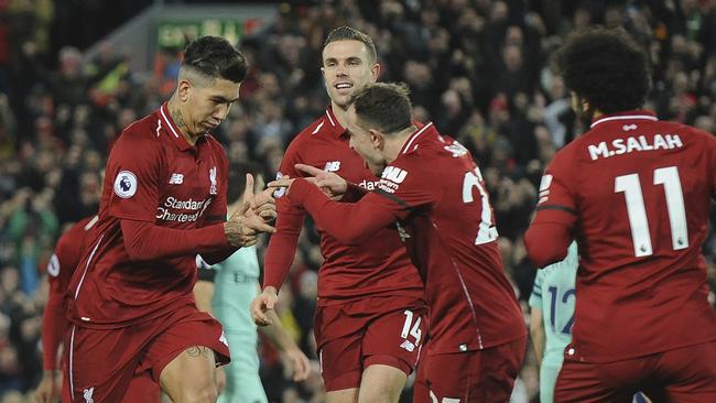 Liverpool's Roberto Firmino, left, celebrates with teammates. Picture: AP