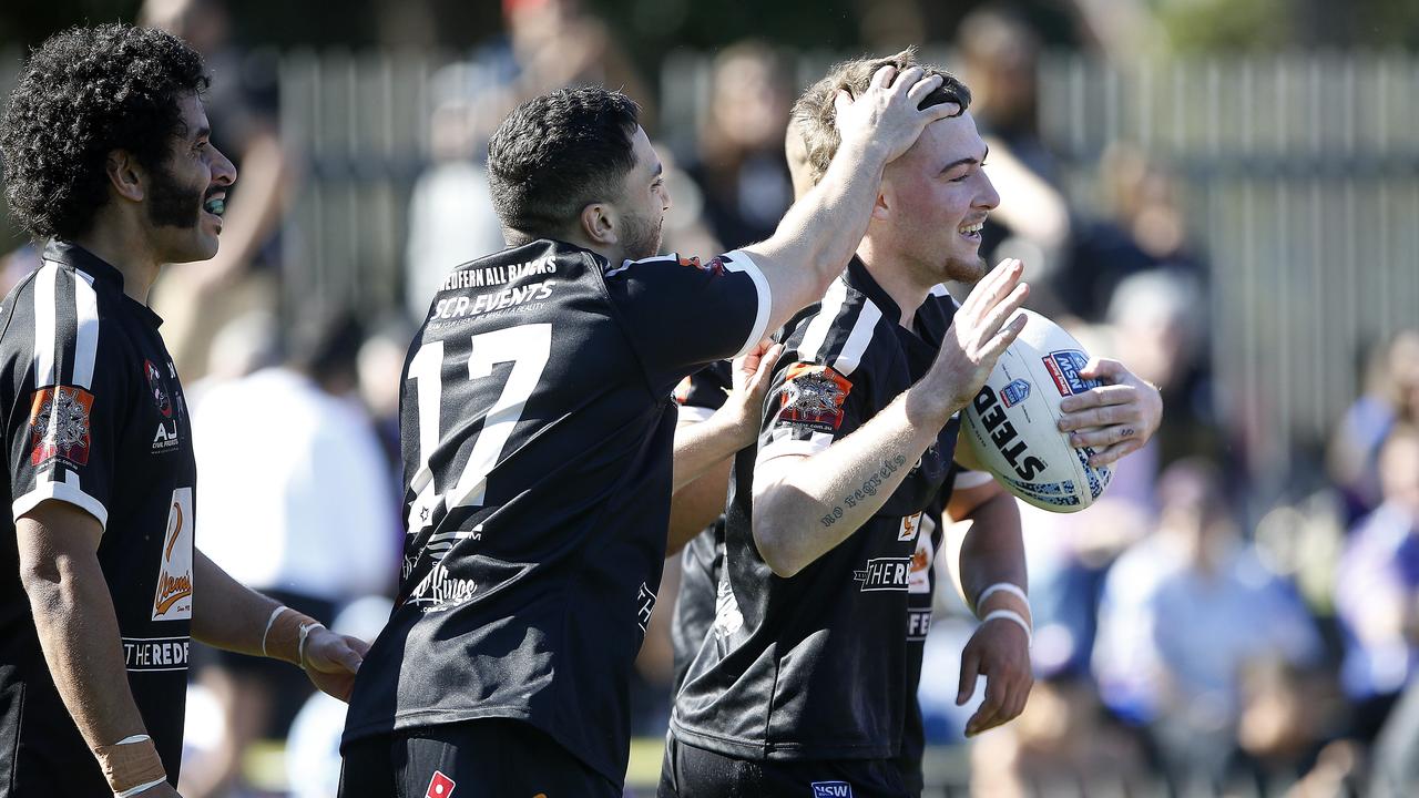 Redfern's Jedd Windle is congratulated after scoring a try. Picture: John Appleyard