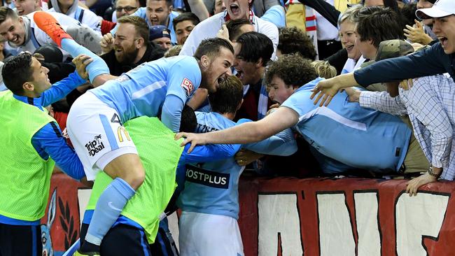 Melbourne City players celebrate with fans after Bruce Kamau scores the side's second goal.