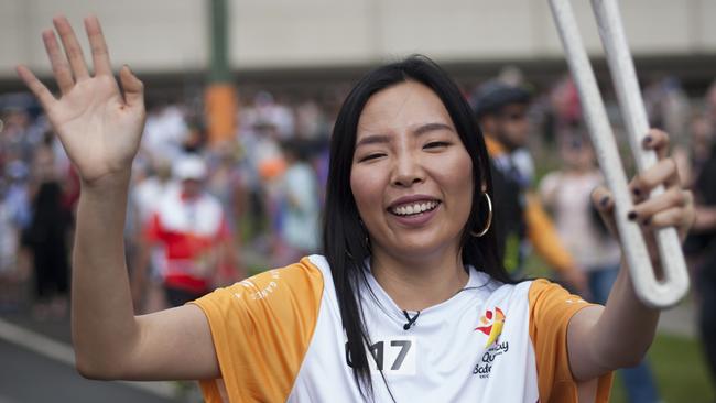 Dami Im carrying the Queen’s Baton at the Daisy Hill Koala Centre in Logan.