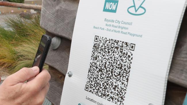 A man scans a playground’s QR code in Melbourne’s Brighton in August. Picture: David Crosling