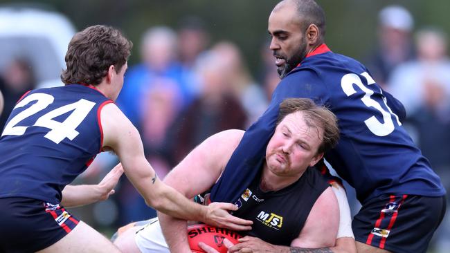 Swifts Creek’s Richard Crabtree and Daniel Hayes surround Omeo-Benambra’s Trent Heesom.