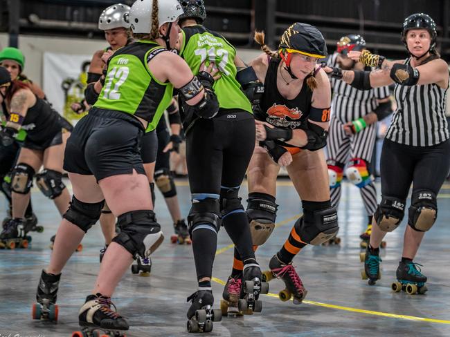 The Bogey Rollers (green) taking on the Harbour Hellcats (black) in the 2022 Newcastle Roller Derby League grand final. Photo: Mark Zouroudis