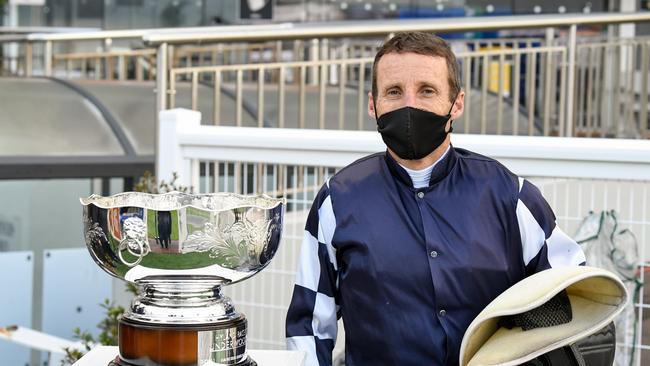 Oliver with the silverware after winning another Group 1.