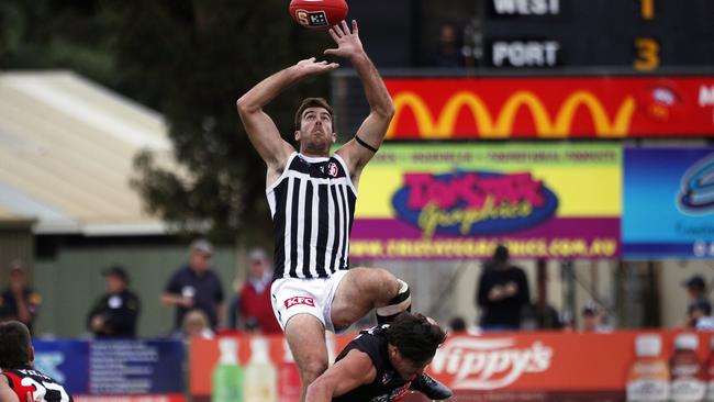 Port Adelaide ruckman Scott Lycett leaps high against West Adelaide at Loxton Oval. Picture: SANFL/Peter Argent.