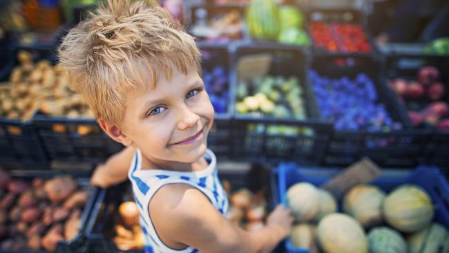 Happy little boy buying local groceries food at the tuscanian farmer's market at Cecina. Italy, Tuscany.  iStock generic markets shopping