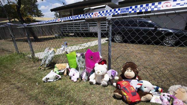 People leave flowers and gifts in memory of two girls who died after being left inside a hot car. Picture: AAP Image/Attila Csaszar