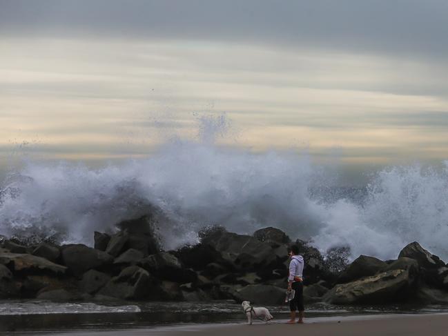 A man takes a picture of the big waves in the breakwater in Venice beach, US. A tsunami advisory was in effect for the West Coast of the US. Picture: Apu Gomes/Getty Images/AFP