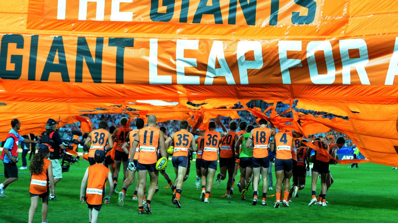 The GWS Giants run out for their inaugural game with a now star-studded line-up. (AAP Image/Dean Lewins)