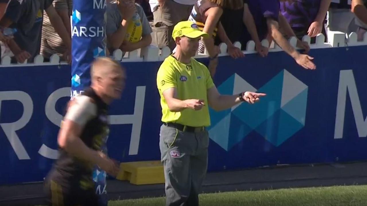 A goal umpire signals a major during the Richmond vs Collingwood Marsh Community Series match.