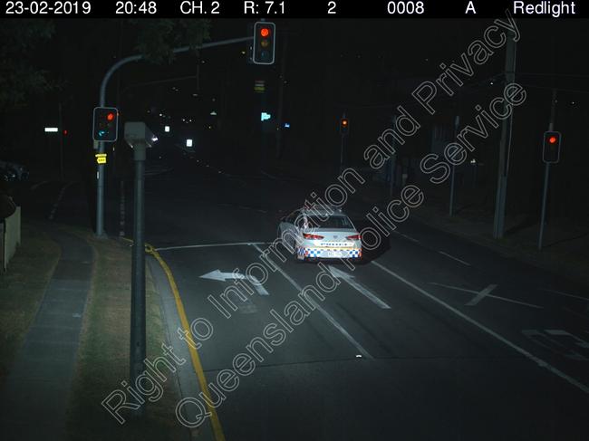 A police car runs a red light.