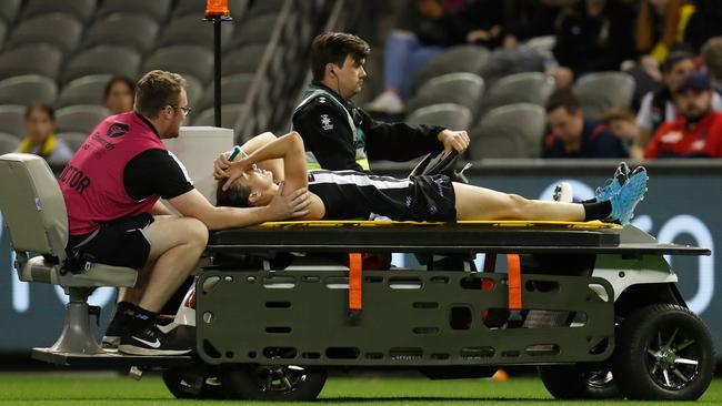 Ash Brazill is taken from the field after rupturing her ACL playing for the Magpies in the AFLW. Photo: Getty Images