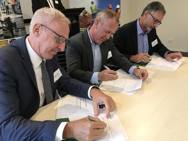 Newcastle University deputy Vice chancellor Kevin Hall, Regional Development Australia Central Coast CEO John Mouland and Central Coast Industry Connect executive office Frank Zammit sign the memorandum of understanding.