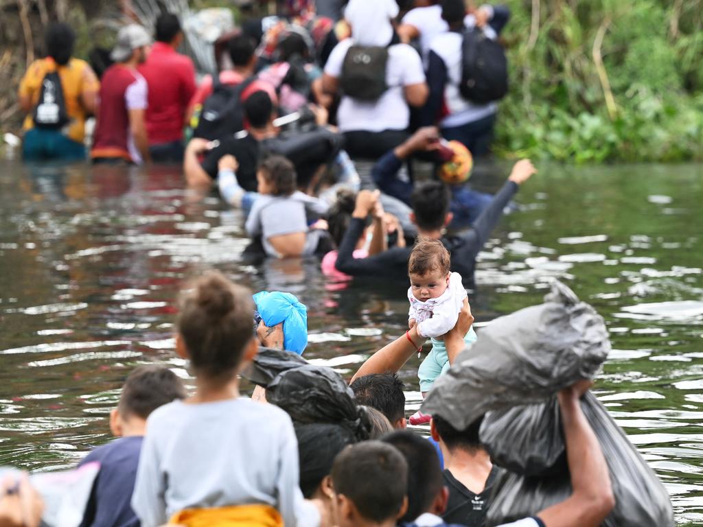 Illegal aliens try to enter the US through the Rio Grande. Picture: Alfredo Estrella/AFP