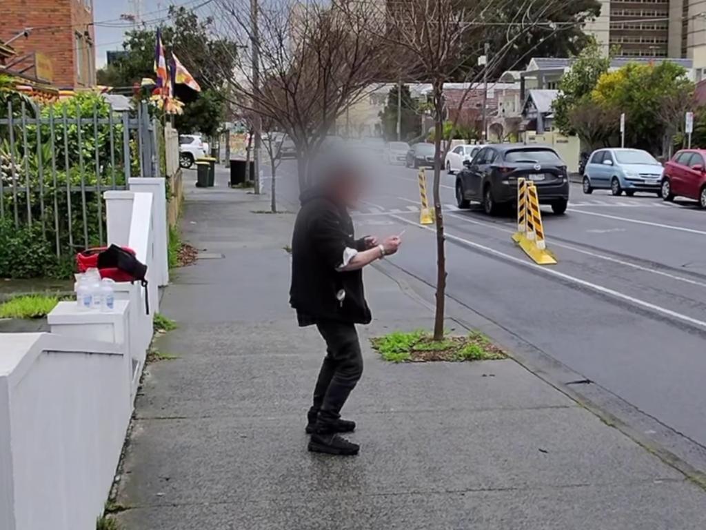 An addict is seen shooting up on the street in North Richmond. Picture: news.com.au