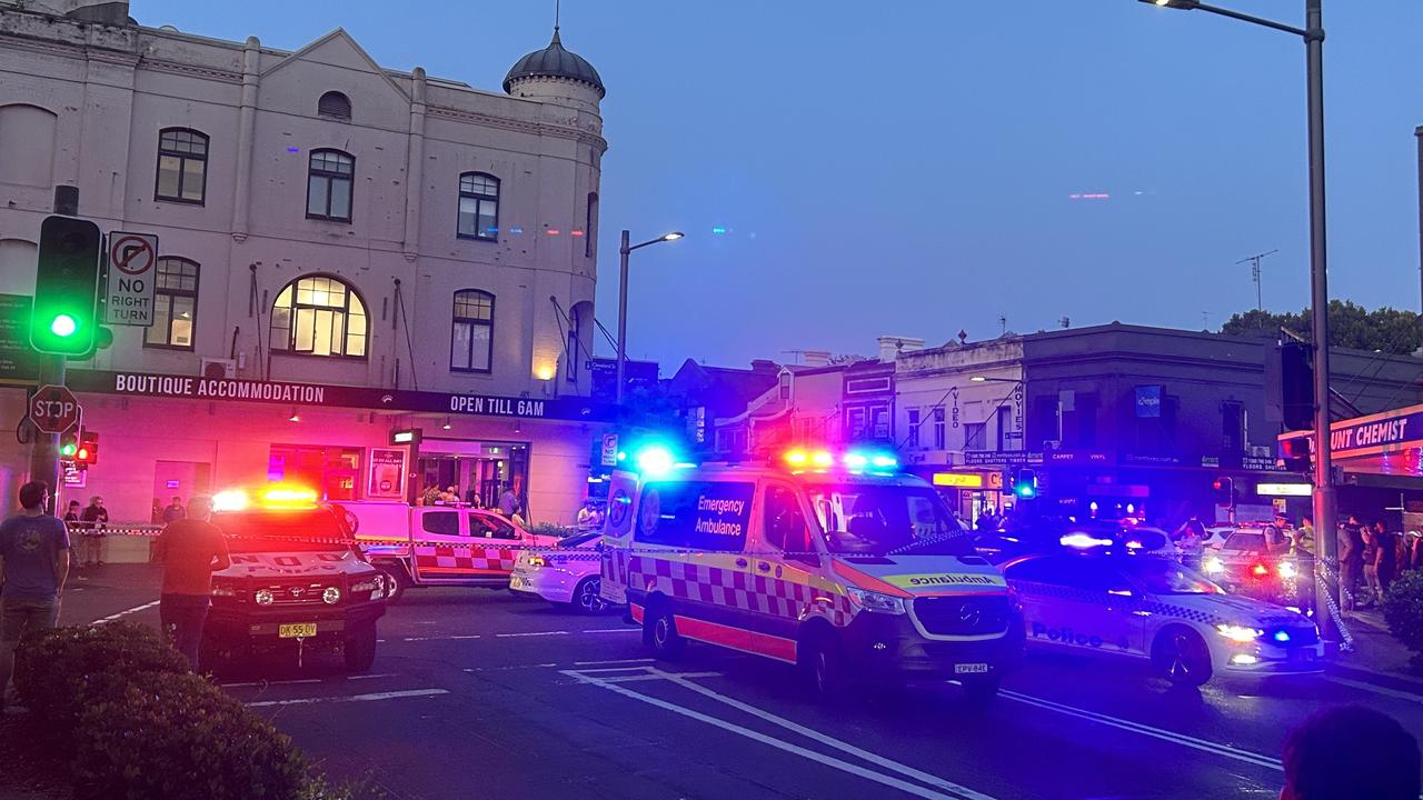 Police cars and ambulances rush to the scene of the Cleveland St shooting. Picture: Elliott Stewart