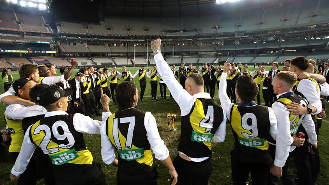 Richmond celebrate back in the middle of the ground with the Premiership Cup, singing the song. Picture: Phil Hillyard