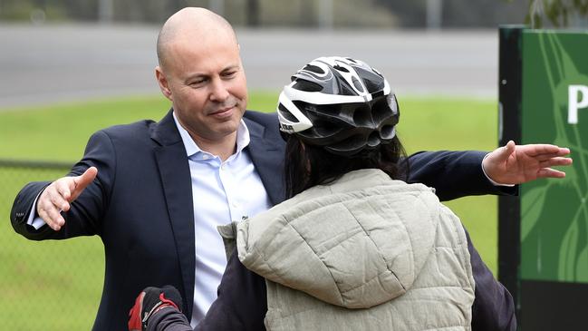 Josh Frydenberg is consoled by wellwishers after the Liberal Party election bloodbath. Picture: Andrew Henshaw