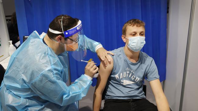 Jacob Sutton 28, gets the AstraZeneca vaccine at the Melbourne Exhibition Centre. Picture: David Caird