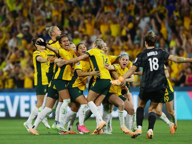 Matildas players celebrate winning the FIFA Women's World Cup Quarter final match against France in a penalty shootout at Brisbane Stadium. (Photo: Lachie Millard.)