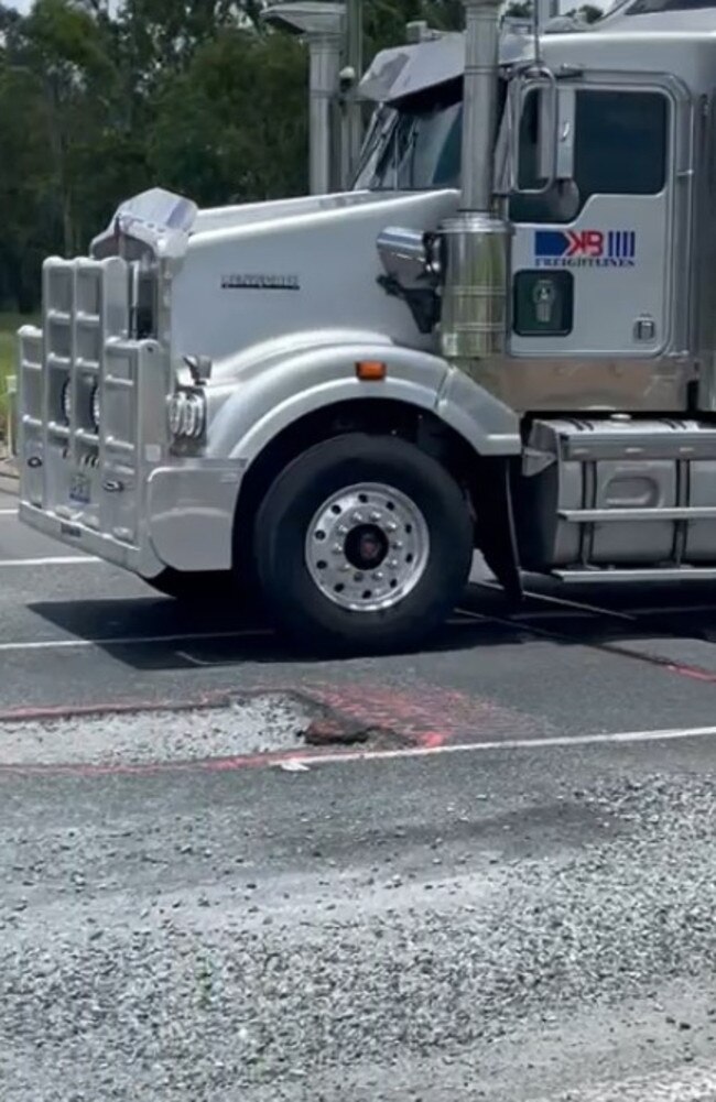 Motorists are having to swerve over solid white lines to avoid a massive pothole near Koumala south of Mackay along the Bruce Highway. Picture: Mitchell Dyer