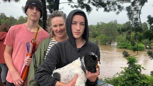 Reuben and Sol Herzberg and Sacha Booms watch the flood waters flow over the skatepark and Lavenders Bridge from the observation deck near Kombu Wholefoods.