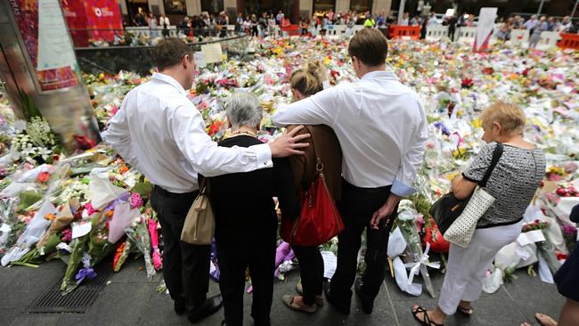 Streams of people left flowers at the memorial for victims Tori Johnson and Katrina Dawson in Martin Place in the days following the siege. MS Dawson’s family visited the site three days after the tragedy. Picture: John Grainger.