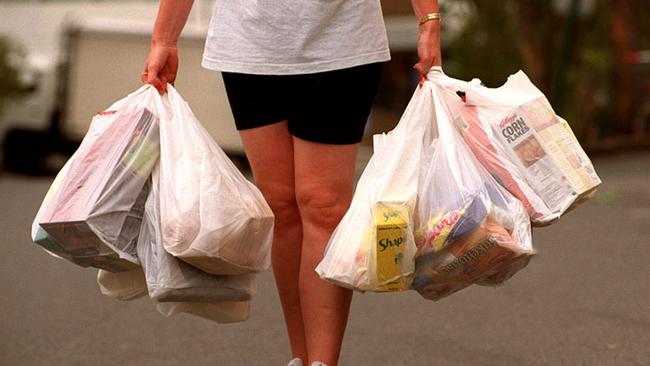 Person carrying non-degradable plastic shopping bags. These bags will be banned and only multi-use bags used which are better for the environment 06 Jan 2009.