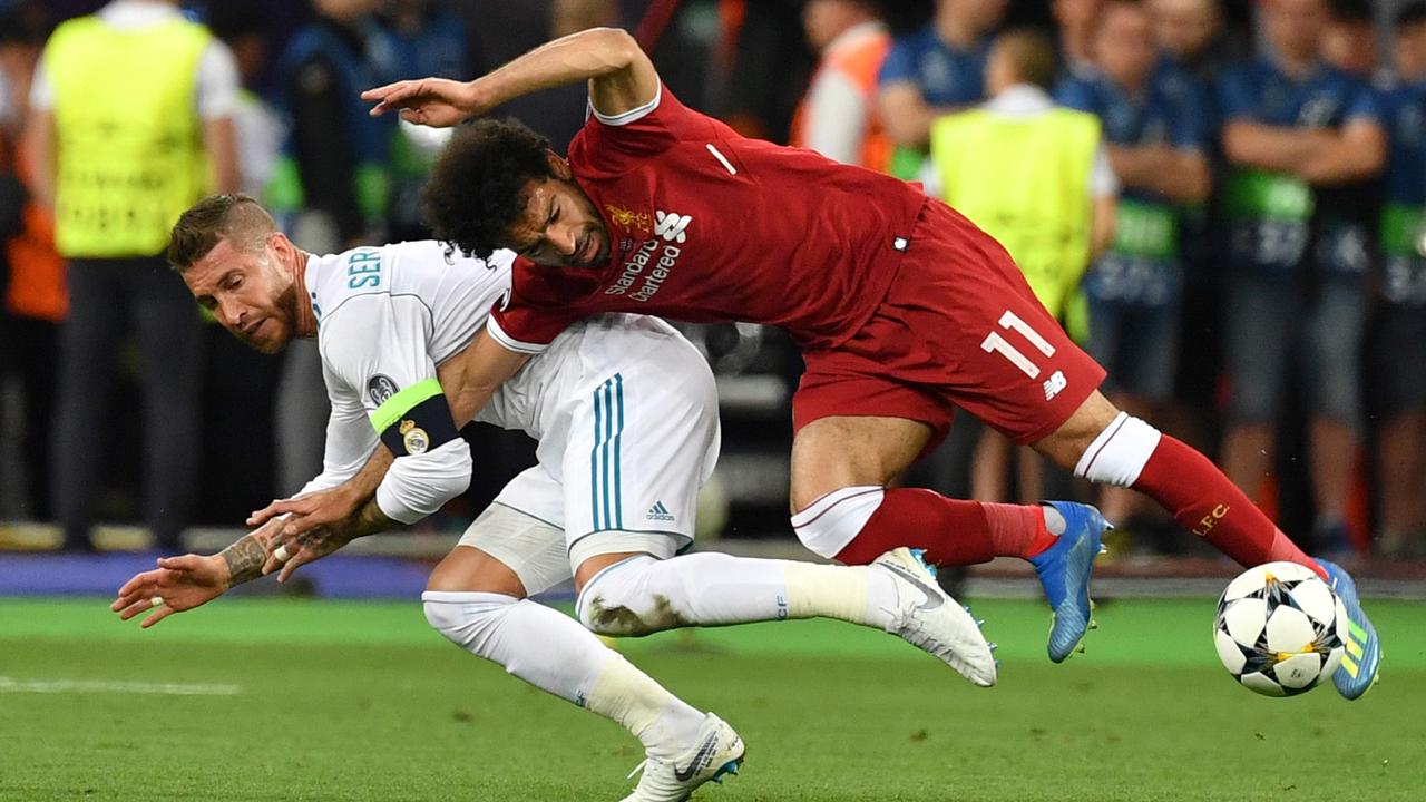 Madrid captain Sergio Ramos (left) in the tackle that injured Liverpool and Egypt star Mohamed Salah.