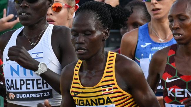 (FILES) (From L to R) Kenya's Rosemary Wanjiru, Israel's Lonah Chemtai Salpeter, Uganda's Rebecca Cheptegei and Kenya's Selly Chepyego Kaptich compete in the women's marathon final during the World Athletics Championships in Budapest on August 26, 2023. A Ugandan marathoner who competed at the Paris Olympics is in intensive care after  being set on fire alledgedly by her partner in Kenya, officials said on September 3, 2024, the latest horrific incident of gender-based violence in the East African country. Long-distance runner Rebecca Cheptegei, 33, was assaulted after her Kenyan partner Dickson Ndiema Marangach reportedly snuck into her home in western Trans-Nzoia county on September 1, 2024 at around 2:00 pm while she and her children were at church, police said. (Photo by Ferenc ISZA / AFP)