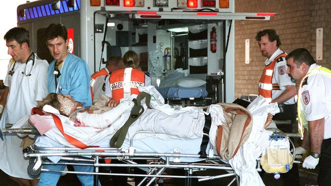 Dr Didier Palmer (in blue) helps wheel injured Bali Bombing victims into Royal Darwin Hospital.